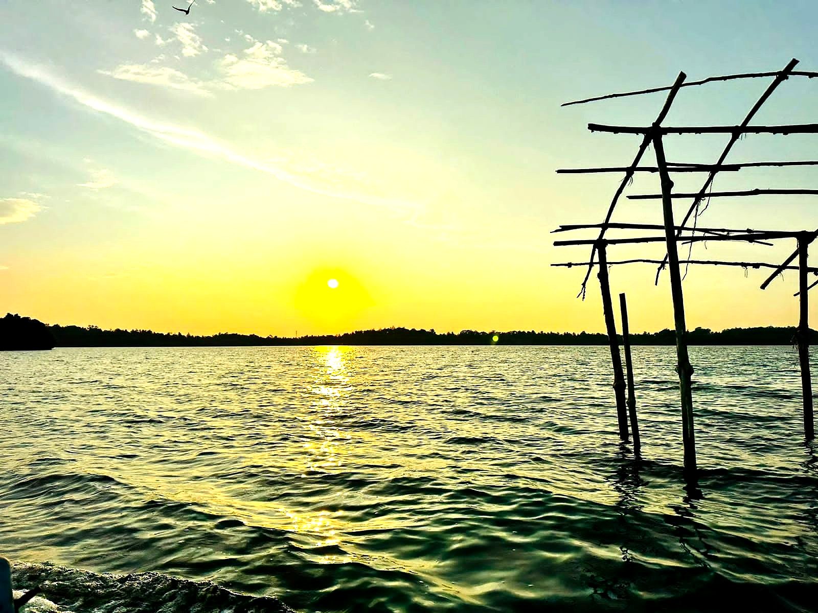 Sunset over a Sri Lankan lagoon, seen from a Volata Travels boat safari